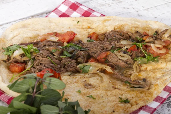Türkçe ve Arapça geleneksel Delicious ramazan kuzu sığır eti kebabı soğan, domates, maydanoz ve rustik beyaz ahşap zemin üzerinde özel sosu ile flatbreadserving üzerinde.