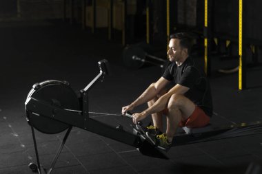 Bir spor salonunda egzersiz kadar genç sporcuların performans itmek. Karanlık fotoğraf konsepti ile kopyalama alanı metin alanı.