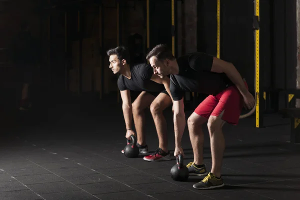 Focused Motivated Strong Young Fitness Friends Sportswear Crouching Kettlebells Reversed — Stock Photo, Image