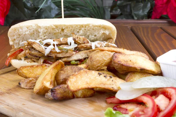 Burrito with grilled chicken and vegetables serving with beer on wood table background. (fajitas, pita bread, shawarma)