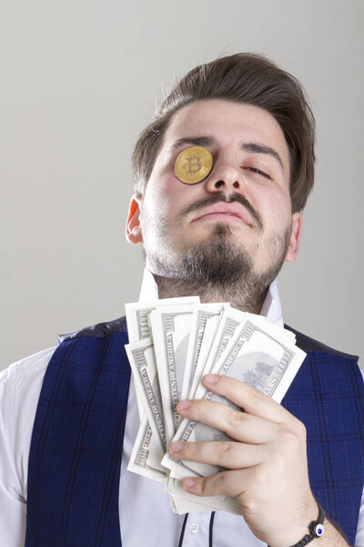 businessman with money and bitcoin on grey background