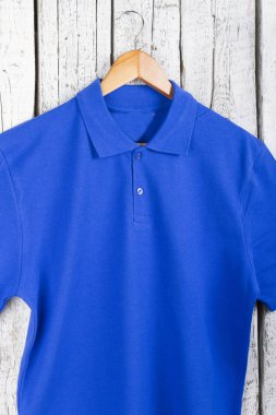 şık mavi gömlek görünümü askı üzerinde ahşap duvar arka plan üzerinde kadar kapatın