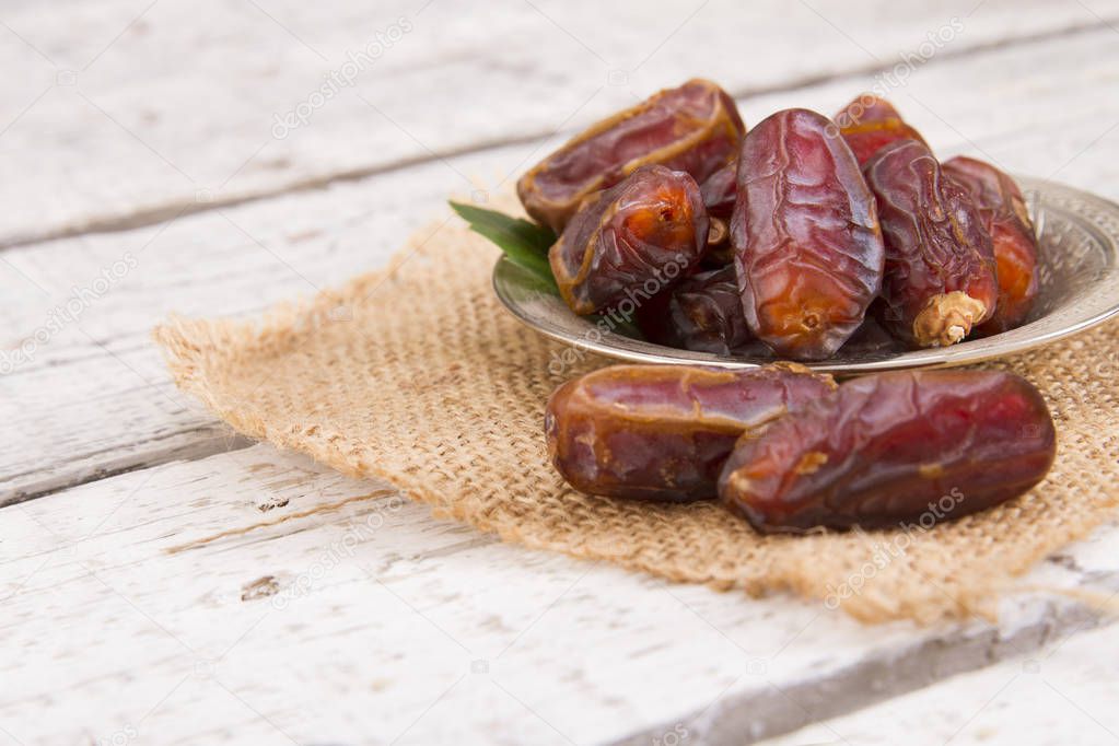 sweet dried dates served on wooden table