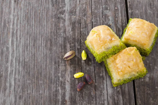 sweet pistachio cakes served on wooden background