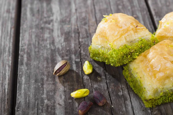 sweet pistachio cakes served on wooden background