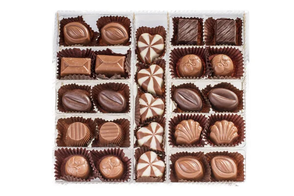 top view of arranged sweets in box on white backdrop