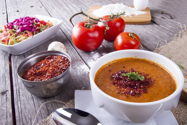 tasty homemade soup with tomatoes served on wooden tabletop