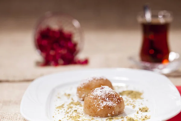 close up view of delicious dessert and cup of hot tea served on table