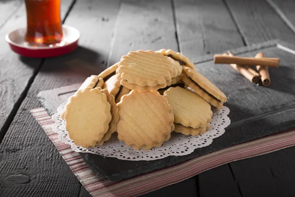 close up view of tasty bakery and cup of tea on wooden background