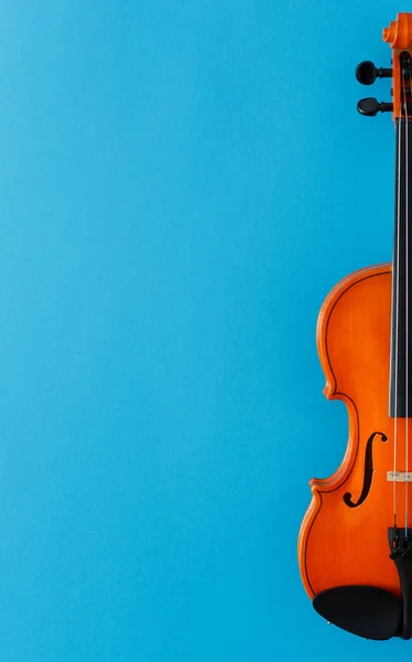 Classical music concert poster with orange color violin on blue background with copy space for your text