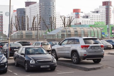 Minsk, Belarus -  March 08, 2019: Parking violation - silver Jeep Grand Cherokee car parked on the sidewalk clipart
