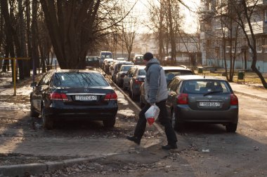Minsk, Belarus -  March 09, 2019: Parking violation on walkways, lawns, crosswalks, no parking signs, public transportation stops. clipart