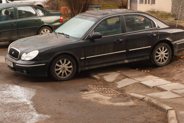 Minsk, Belarus -  March 14, 2019: Parking violation on walkways, lawns, crosswalks, no parking signs, public transportation stops.