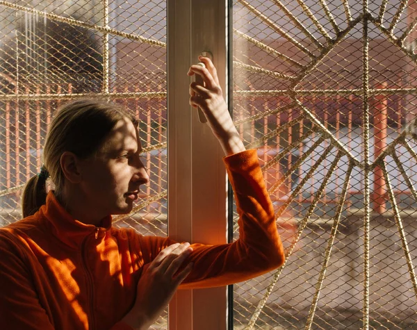 Adult Young Woman Orange Clothes Smiling Looking Out Window Bars — Stock Photo, Image