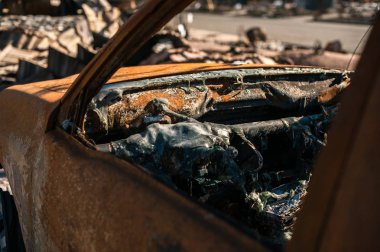 Exterior close-up of a burned to the ground car wreck. clipart