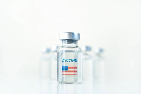 Transparent vials with USA flag. Vaccine for covid-19 coronavirus, flu, infectious diseases. Injection after clinical trials for vaccination of human, child, adult, senior. Medicine, drug concept.