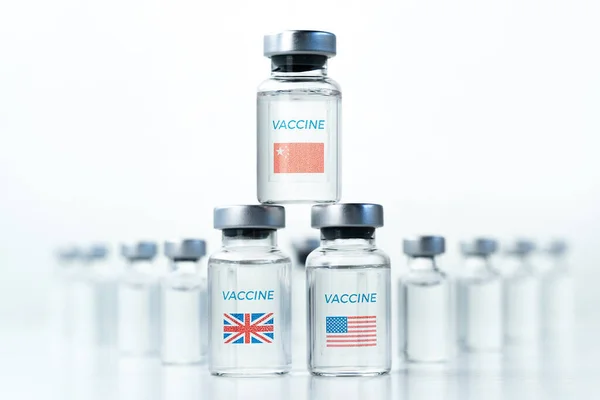 Transparent vials with USA, UK, China flag. New vaccine for covid-19 coronavirus, flu,infectious diseases. Injection after clinical trials for mass vaccination of human,people. Medicine, drug concept.