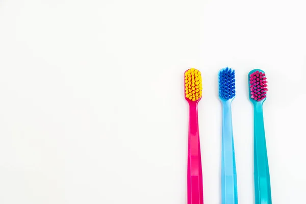 Three color toothbrushes on wite isolated background — Stock Photo, Image