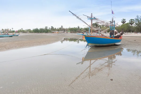 Barco de pesca de madeira na praia da maré baixa . — Fotografia de Stock