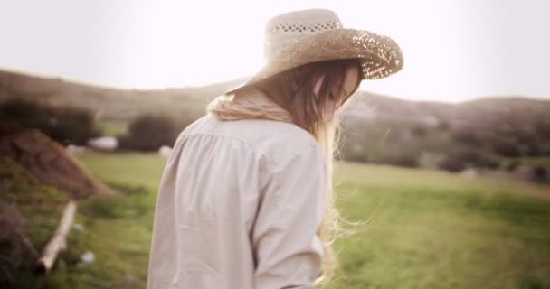 Beautiful teen girl with blond hair walking in the country — Stock Video