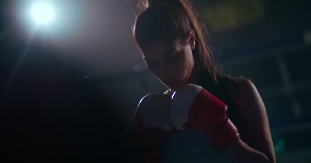 Молодая боксерша готовится к ночному бою — стоковое видео