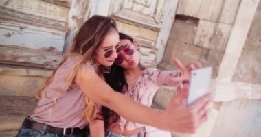 Hipster kadınlar eski İtalyan kasabasında tatil yaparken selfie çekiyorlar.