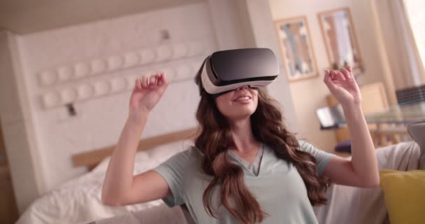 Hermosa joven que tiene una experiencia de realidad virtual en casa — Vídeo de stock