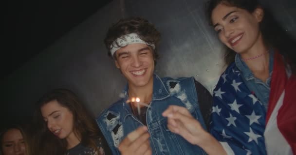 Hipster teenage friends having fun with American flag and sparklers — Stock Video