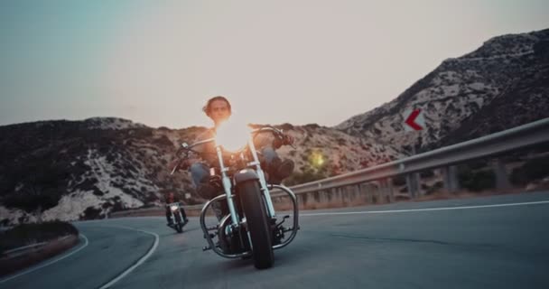 Kru pengendara sepeda motor pemberontak di jalan raya pegunungan saat matahari terbenam — Stok Video