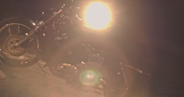 Rebel biker with motorcycle drifting around bonfire at night — Stock Video