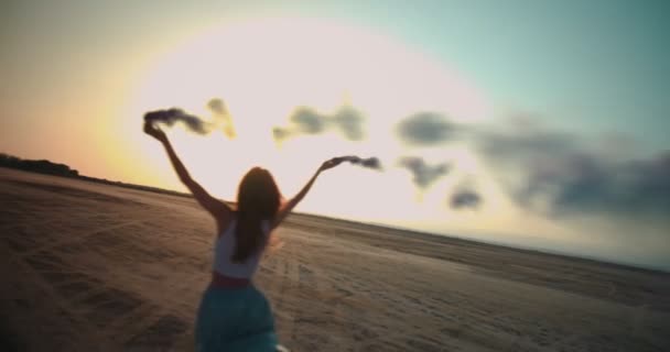 Young woman having fun with smoke bombs at sunset — Stock Video