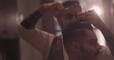 Genç hippi, modası geçmiş berbere tıraş oluyor.