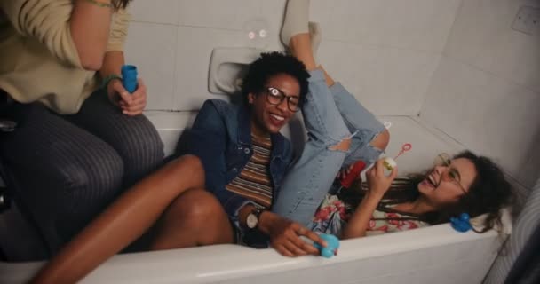 Happy teenage girls having fun blowing bubbles at slumber party — Stock Video