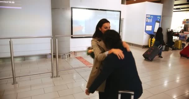 Jovem levantando e acolhendo esposa no aeroporto — Vídeo de Stock