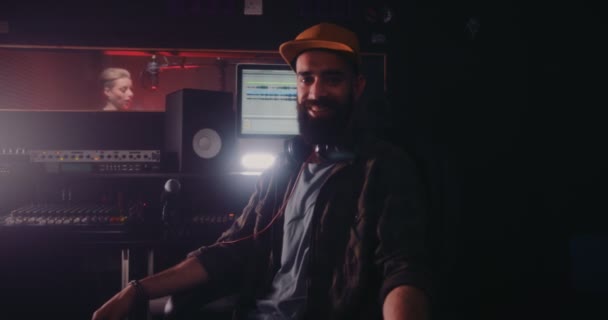 Музыкальный продюсер и звукорежиссёр, работающий в профессиональной студии звукозаписи — стоковое видео
