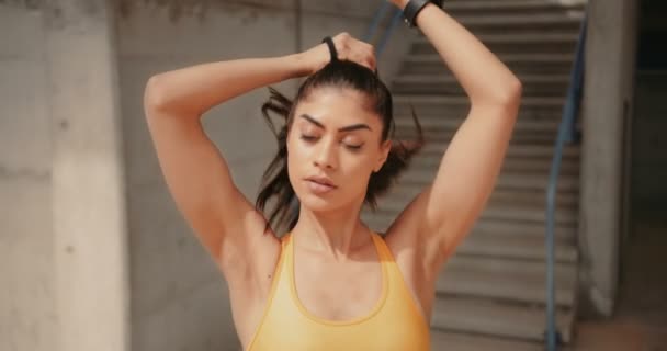 Young sporty woman getting ready for workout in the city Royalty Free Stock Video