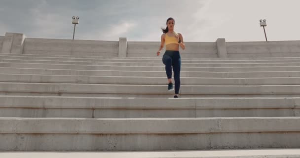 Young athletic woman doing sports training on urban stadium stairs — Stock Video