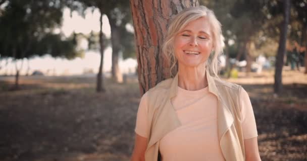 Portrait of smiling mature woman in the forest in autumn — Stock Video