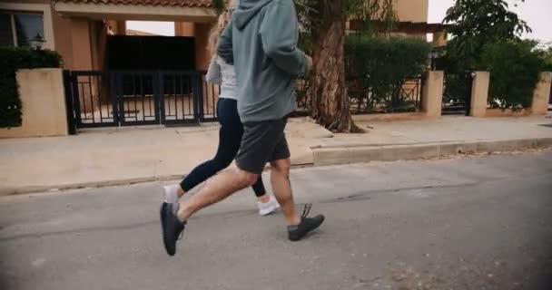 Sénior casal multi-étnico exercitando juntos e correndo em ruas suburbanas — Vídeo de Stock