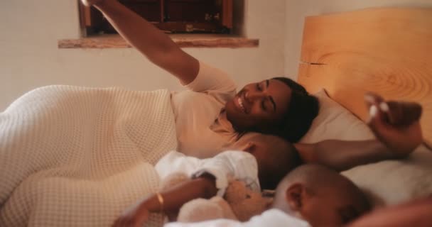 Νεαρή μητέρα ξυπνάει με μικρά αγόρια να κοιμούνται στο κρεβάτι — Αρχείο Βίντεο