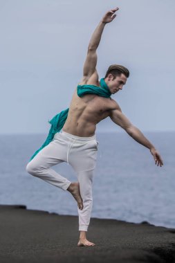 Atletik adam el kaldırma ve tek bacak üzerinde bir kenara bükme