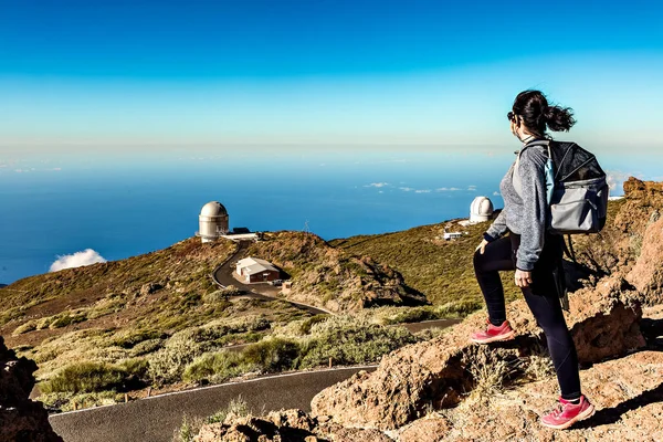 Woman observing from above La Palma Astrophysical Research Center located in the Canary Islands