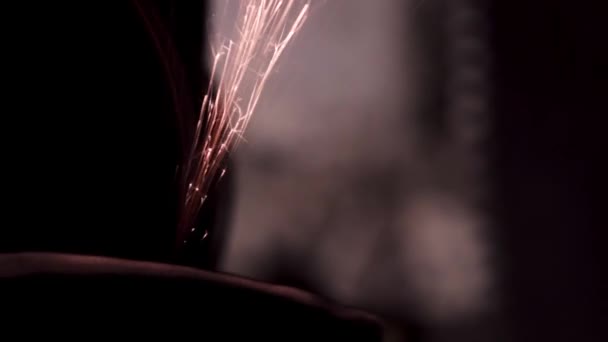 Sharpened close-up in the dark with bright sparks. copy space — Stock Video