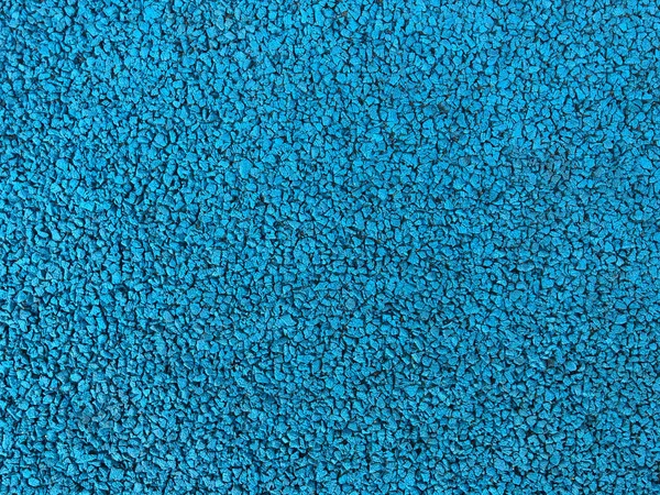 Каучуковое спортивное покрытие синего цвета. Абстрактный фон и текстура для дизайна — стоковое фото