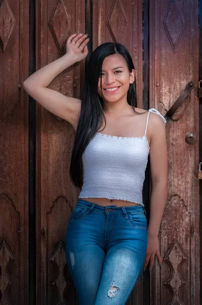 Happy Hispanic Woman Long Black Smiling Hair Leaning Wooden Door — Stock Photo, Image