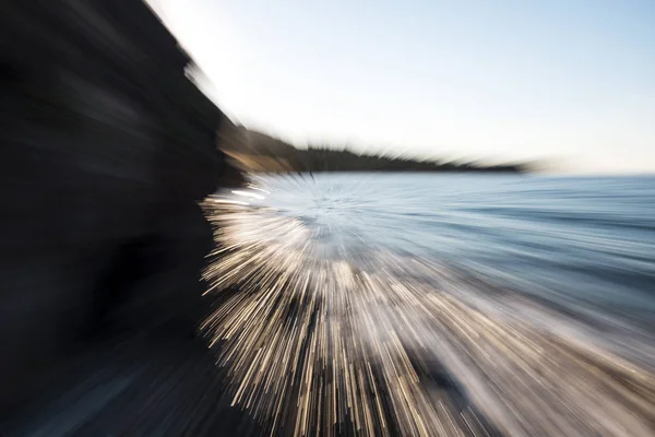 Abstract background zoom in zoom out technic photo of waves on the beach.