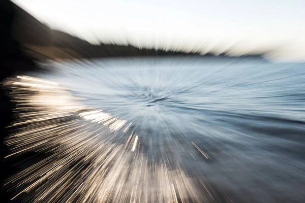 Abstract background zoom in zoom out technic photo of waves on the beach.