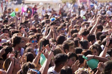 Izmir, Turkey - October 15, 2017: Crowded people at Colored Powder Paint festival at Izmir Buca Golet. clipart