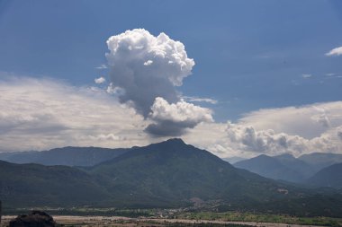 Cumulus bulutları Dağların üzerinden Kalambaka Yunanistan, Meteora bölgesinden gibi görünüyor.