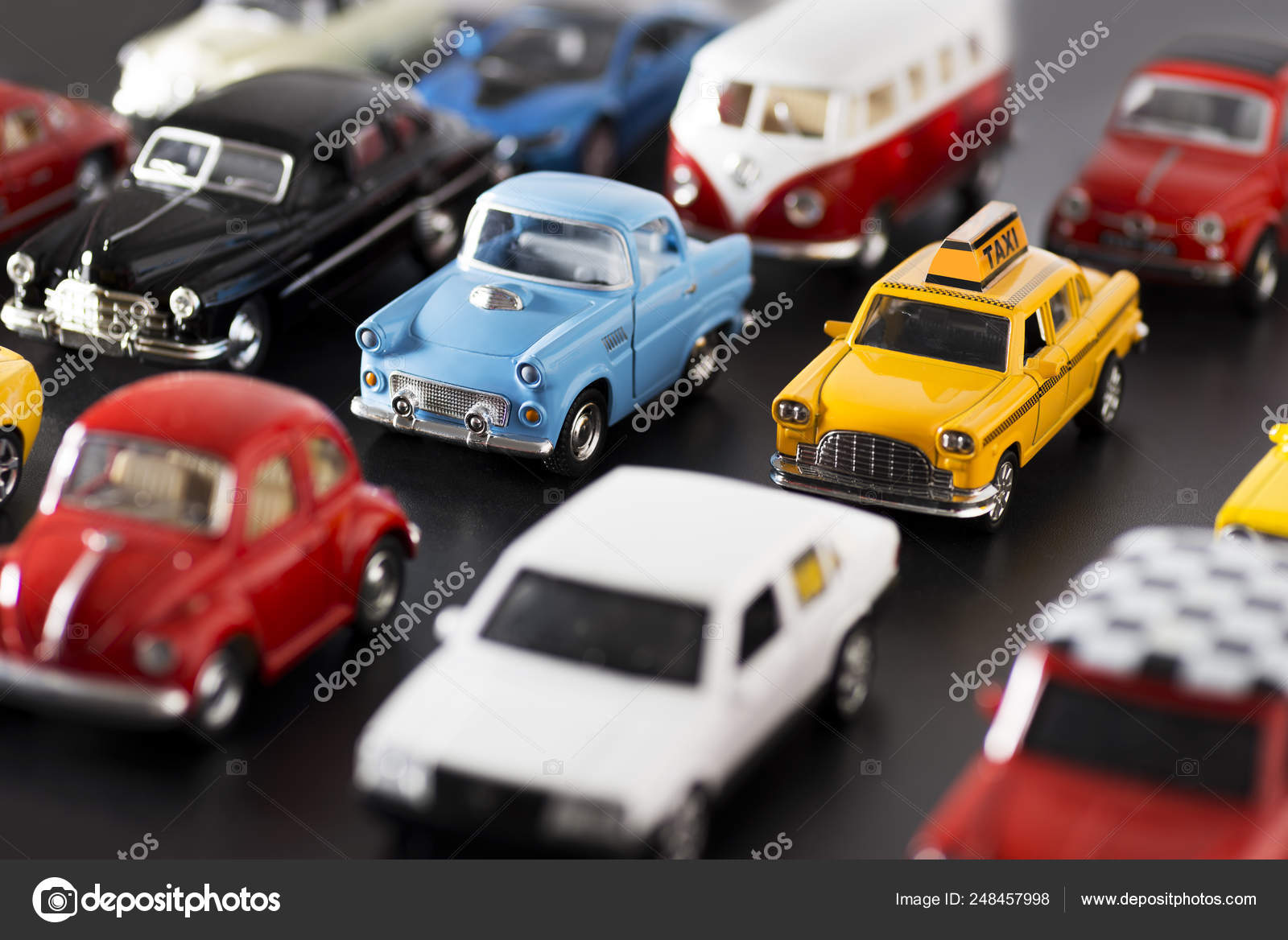 Various some brand toy cars on a black ground looks like a traf